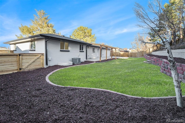 back of house with a fenced backyard, a gate, a yard, central air condition unit, and brick siding