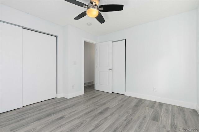 unfurnished bedroom with ceiling fan and light hardwood / wood-style flooring