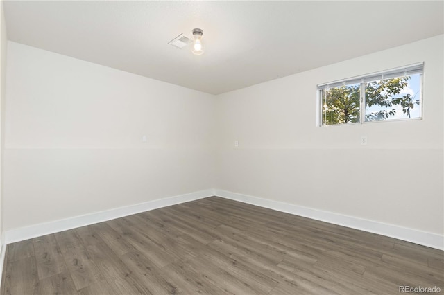 empty room with dark hardwood / wood-style floors