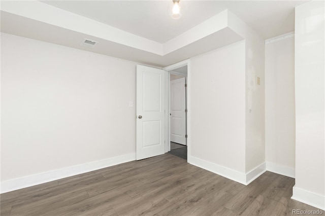 unfurnished room featuring dark wood-type flooring