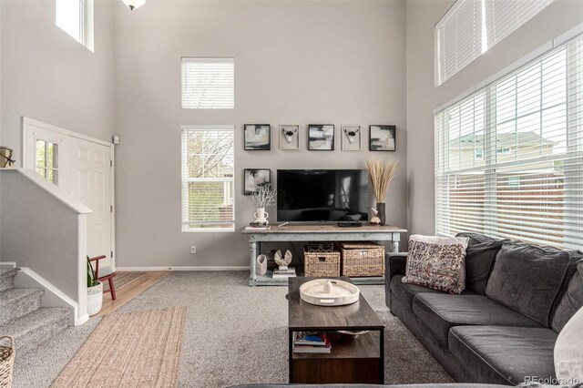 4873 S Fultondale Way, Aurora, CO 80016 - carpeted living room featuring a high ceiling, baseboards, and stairs