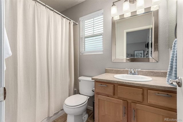 4873 S Fultondale Way, Aurora, CO 80016 - full bath with vanity, toilet, a shower with shower curtain, and a textured wall