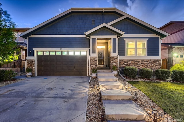 25 N Irvington St, Aurora, CO 80018 - craftsman inspired home featuring driveway, stone siding, and an attached garage