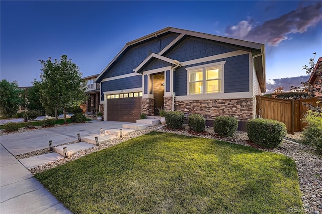 25 N Irvington St, Aurora, CO 80018 - craftsman house featuring concrete driveway, stone siding, and an attached garage