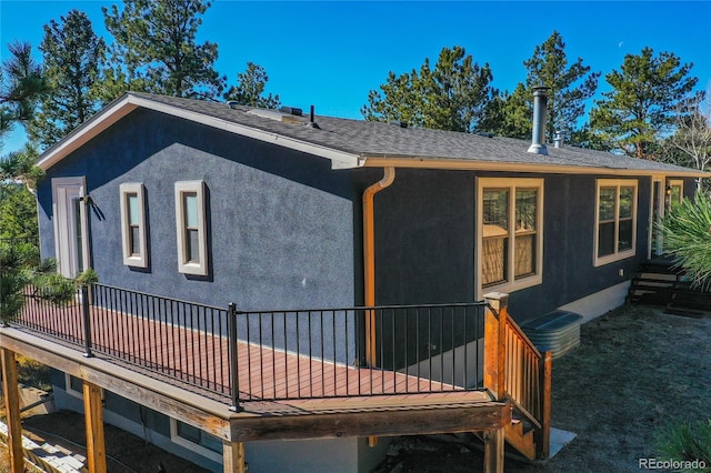 back of property featuring a deck