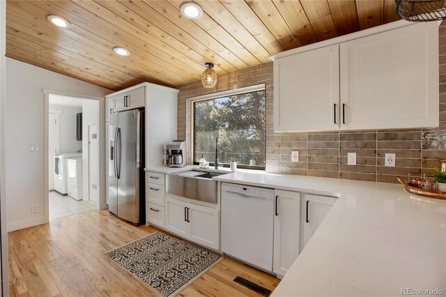 kitchen featuring light hardwood / wood-style floors, white cabinetry, white dishwasher, and stainless steel fridge with ice dispenser