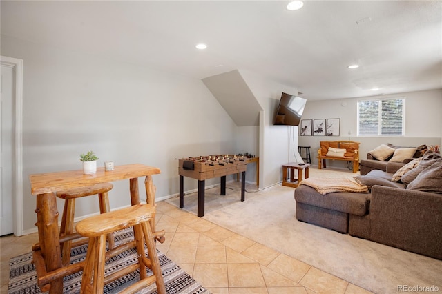 tiled living room featuring vaulted ceiling