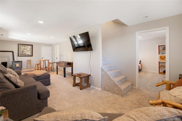 carpeted living room featuring a wood stove