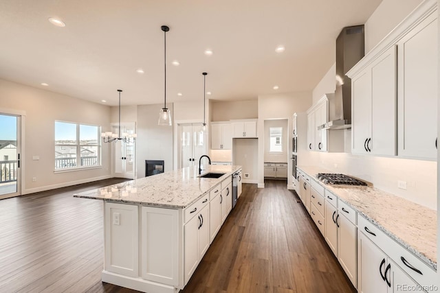 kitchen featuring dark wood-style flooring, white cabinets, a sink, and recessed lighting