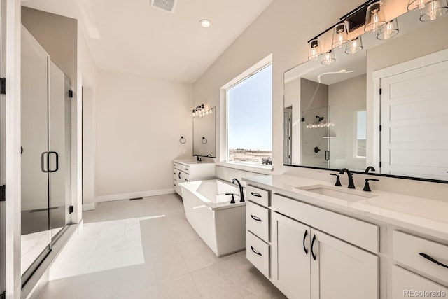 full bathroom featuring tile patterned floors, a sink, a freestanding tub, a shower stall, and two vanities