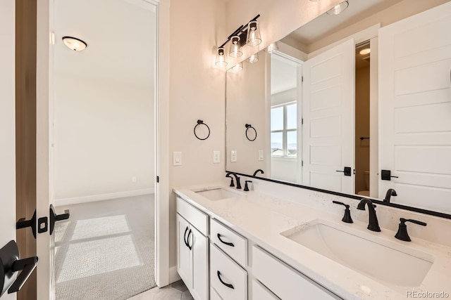 full bathroom featuring baseboards, a sink, toilet, and double vanity