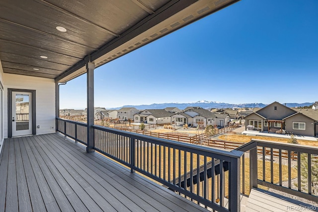 wooden deck with a mountain view and a residential view