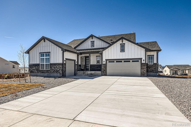 view of front of home with a standing seam roof, roof with shingles, metal roof, and concrete driveway