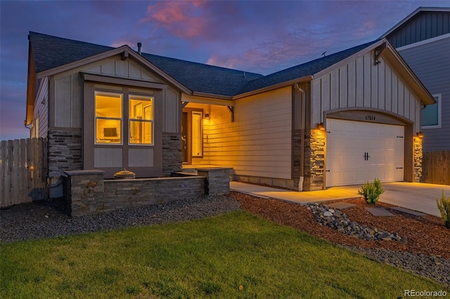 view of front of home with a yard and a garage