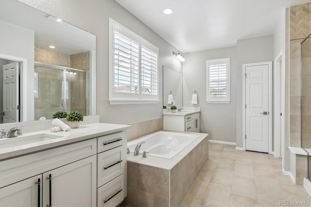 bathroom featuring tile flooring, separate shower and tub, and double vanity