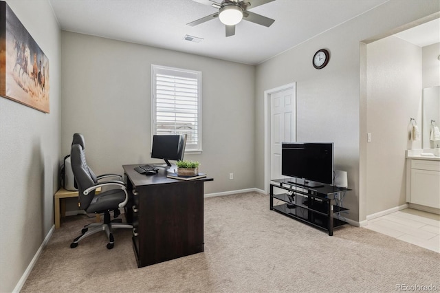 home office featuring light carpet and ceiling fan