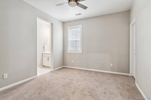 carpeted spare room with ceiling fan