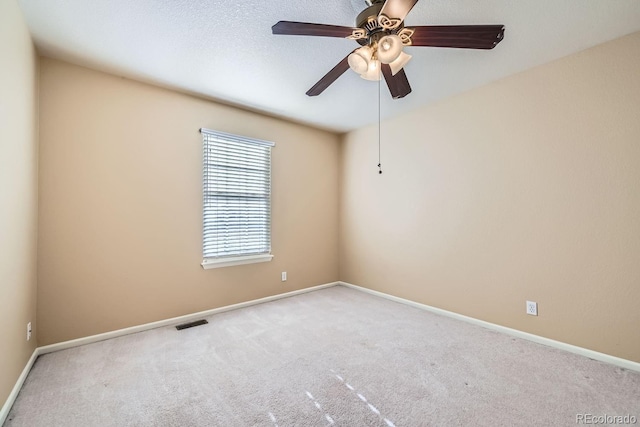 spare room featuring ceiling fan and light colored carpet