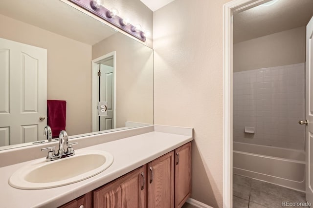 bathroom with tile patterned floors, vanity, and washtub / shower combination