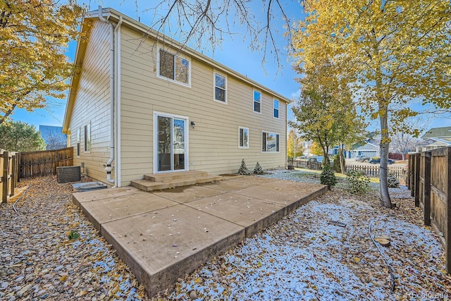 rear view of house with central air condition unit and a patio