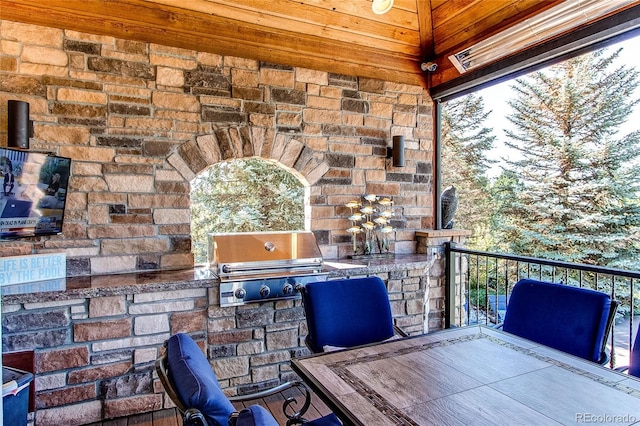 view of patio / terrace with a balcony, grilling area, and exterior kitchen