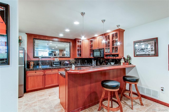 bar with decorative backsplash, hanging light fixtures, light tile patterned flooring, and stainless steel fridge