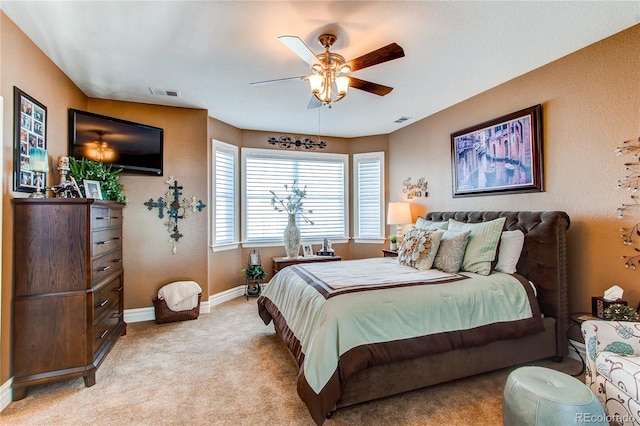 bedroom with ceiling fan and light carpet