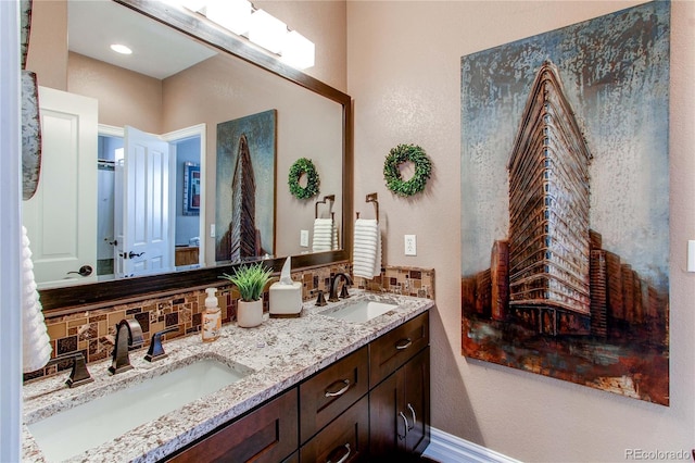 bathroom with tasteful backsplash and vanity