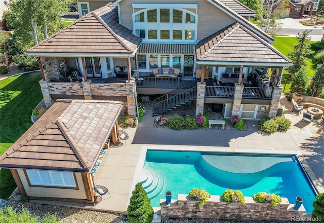 rear view of house with a patio and a pool side deck