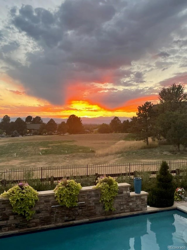 view of pool at dusk