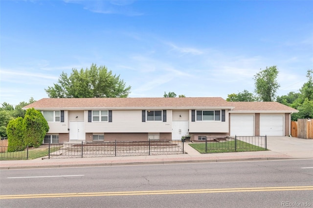 8485 W 44th Ave, Wheat Ridge, CO 80033 - bi-level home with a fenced front yard, driveway, and a garage