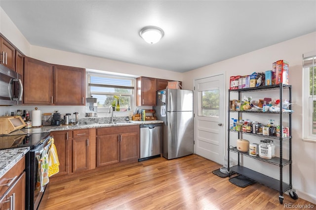8485 W 44th Ave, Wheat Ridge, CO 80033 - kitchen with appliances with stainless steel finishes, plenty of natural light, light wood finished floors, and light stone countertops