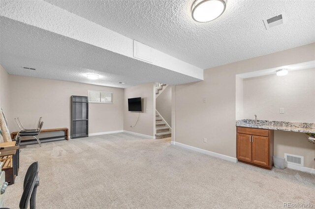 8485 W 44th Ave, Wheat Ridge, CO 80033 - basement with a textured ceiling, light colored carpet, stairway, and bar area