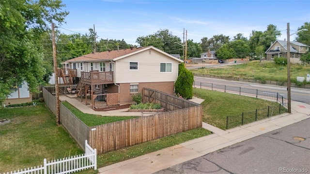 8485 W 44th Ave, Wheat Ridge, CO 80033 - view of front of home with a wooden deck, a fenced backyard, and stairs