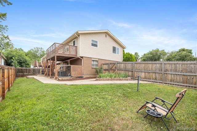 8485 W 44th Ave, Wheat Ridge, CO 80033 - rear view of house featuring a fenced backyard, stairway, a deck, and brick siding
