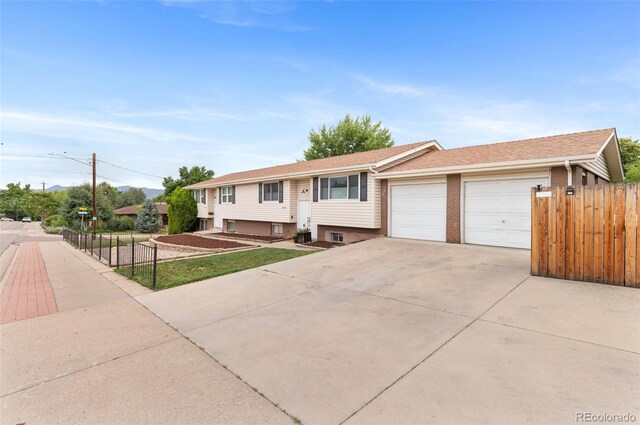 8485 W 44th Ave, Wheat Ridge, CO 80033 - raised ranch featuring concrete driveway and a garage