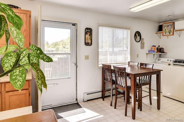 dining room with washing machine and clothes dryer and a baseboard heating unit
