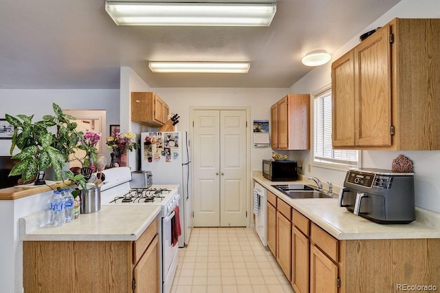 kitchen with sink and white appliances