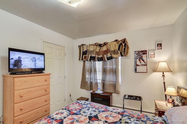 bedroom with a baseboard heating unit