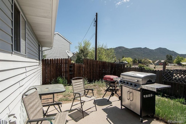 view of patio with grilling area and a mountain view