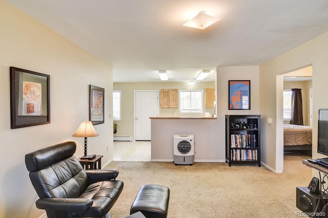 carpeted living room featuring a baseboard radiator and a healthy amount of sunlight