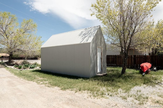 view of property exterior with an outdoor structure