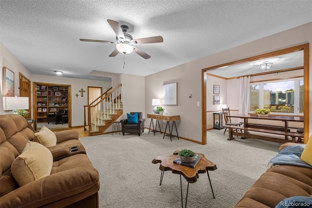 2090 S Gray Dr, Lakewood, CO 80227 - carpeted living area featuring a textured ceiling, stairway, baseboards, and ceiling fan