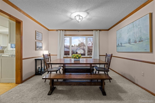 2090 S Gray Dr, Lakewood, CO 80227 - dining space featuring baseboards, light carpet, a textured ceiling, and ornamental molding