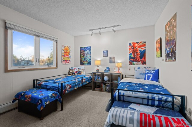2090 S Gray Dr, Lakewood, CO 80227 - carpeted bedroom with baseboard heating, rail lighting, and a textured ceiling