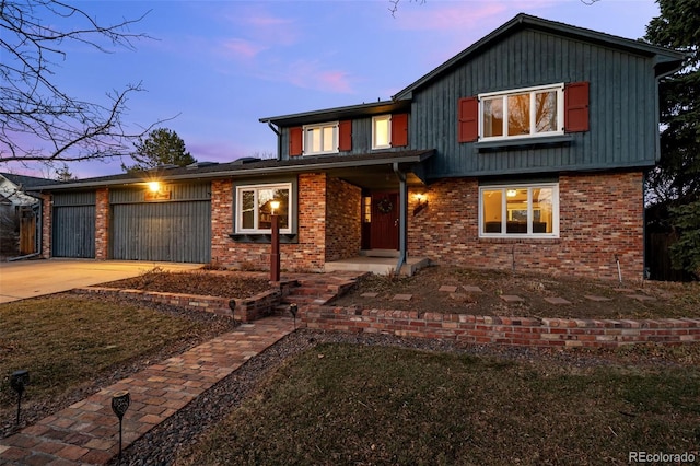 2090 S Gray Dr, Lakewood, CO 80227 - traditional home featuring a garage, brick siding, and driveway