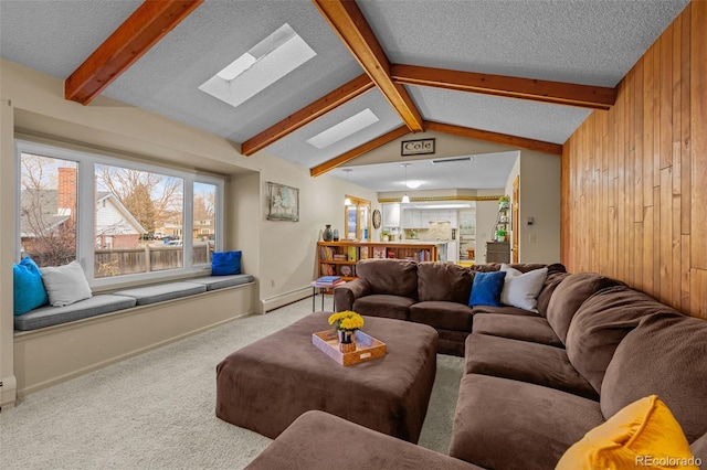 2090 S Gray Dr, Lakewood, CO 80227 - living room featuring a baseboard heating unit, a textured ceiling, vaulted ceiling with skylight, carpet, and wooden walls