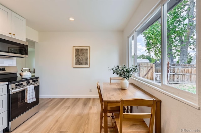 14317 Olmsted Dr, Denver, CO 80239 - dining room with light wood-type flooring, baseboards, and recessed lighting