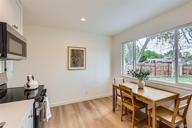 14317 Olmsted Dr, Denver, CO 80239 - dining space with light wood finished floors, recessed lighting, and baseboards