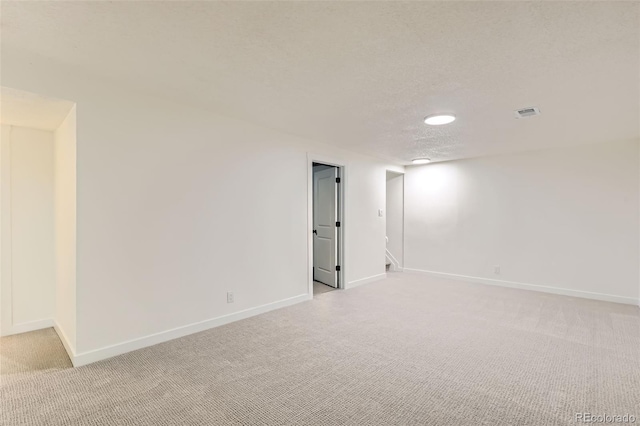 14317 Olmsted Dr, Denver, CO 80239 - empty room with light colored carpet, baseboards, and a textured ceiling